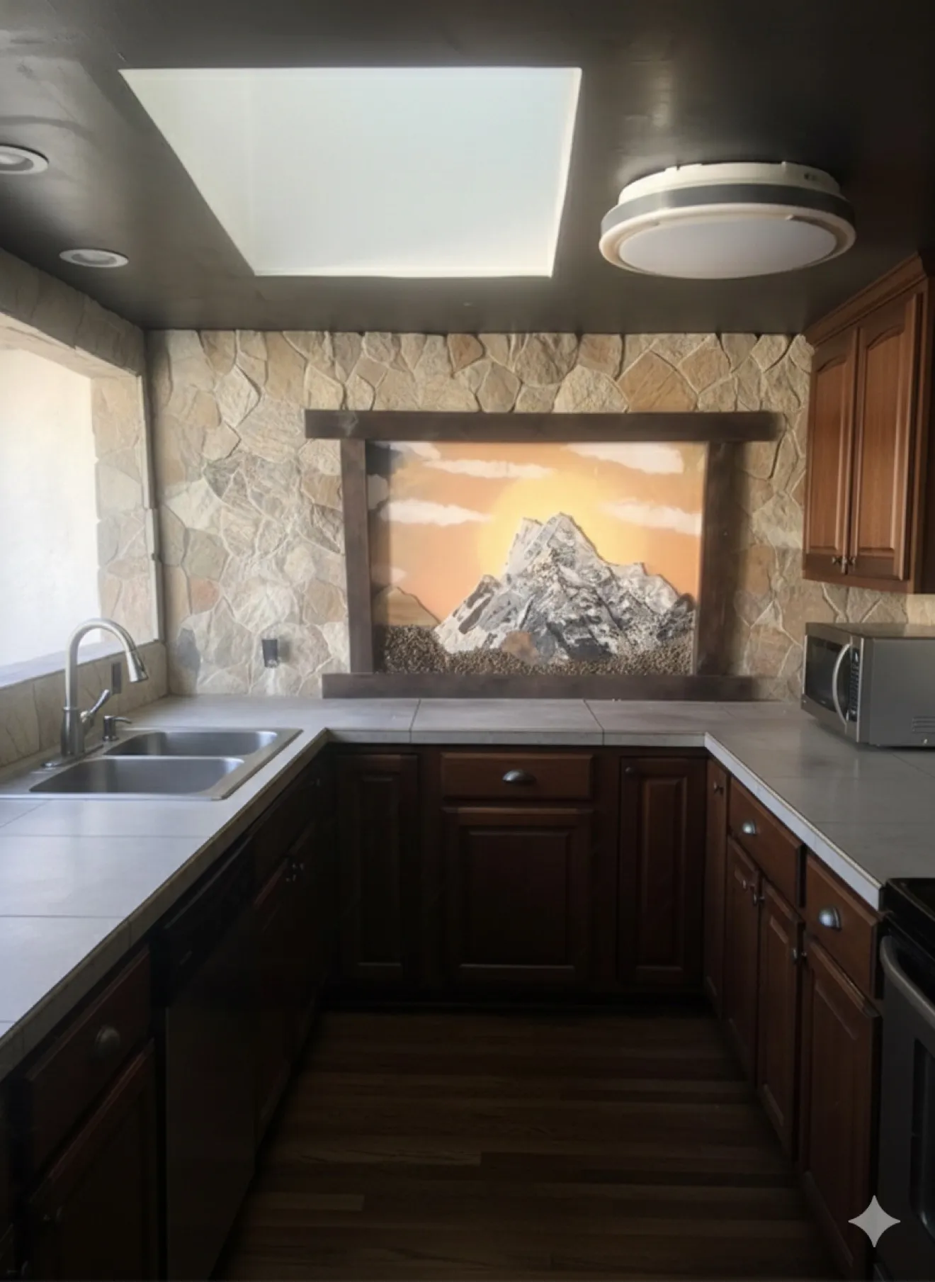 Hand-cut glass mountain landscape mosaic as a kitchen backsplash